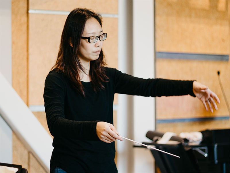 Chaowen Ting conducting the Georgia Tech Orchestra in a rehearsal.
