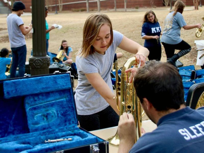 A member of the band maintaining instruments.