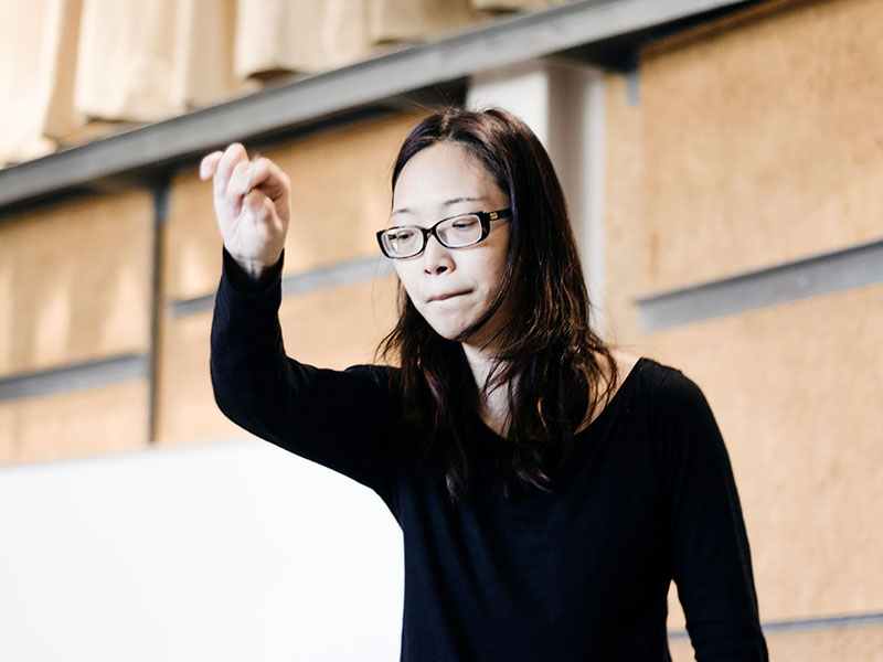Chaowen Ting conducting at a rehearsal.