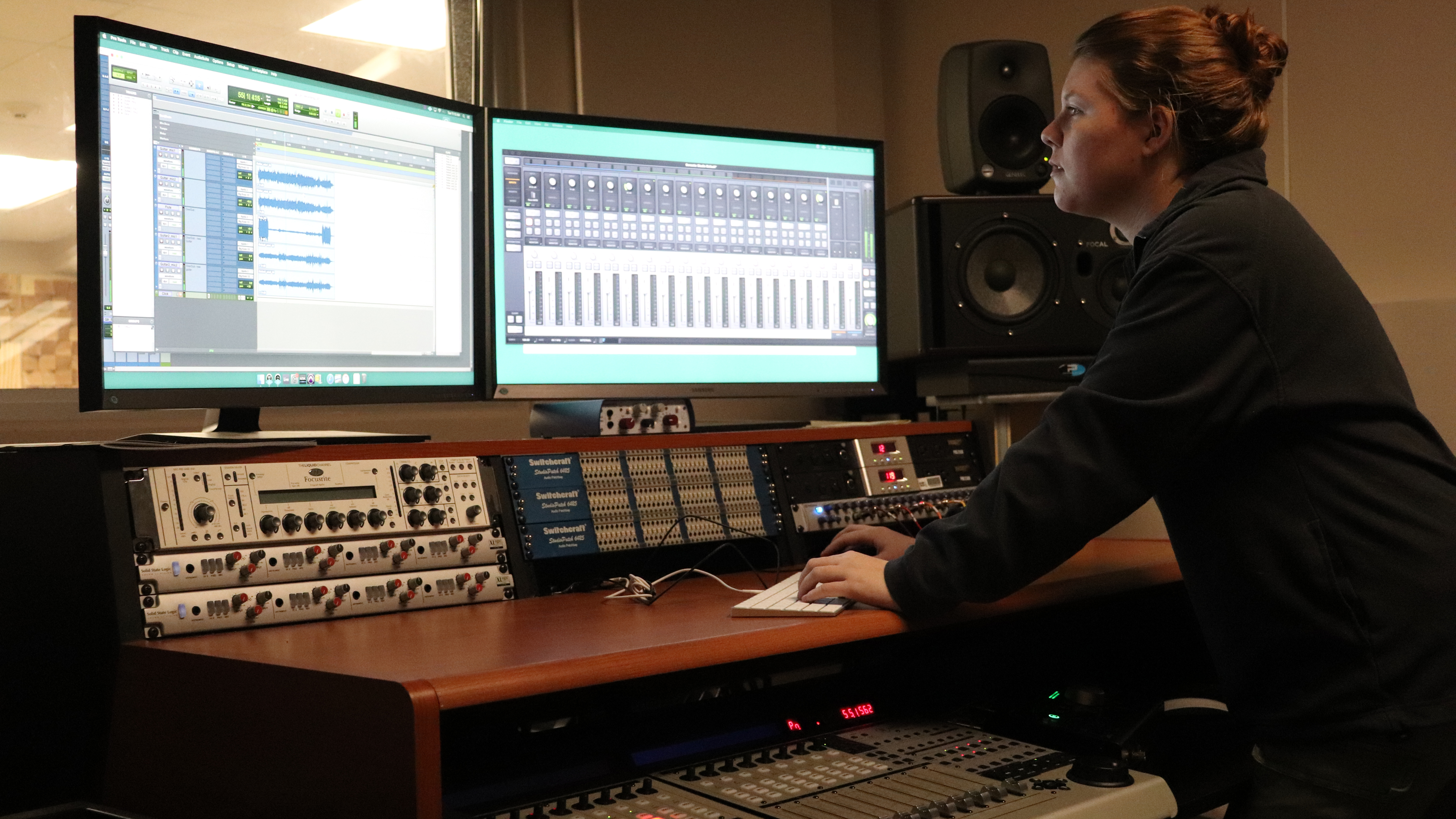 A student at a studio working on a recording track.