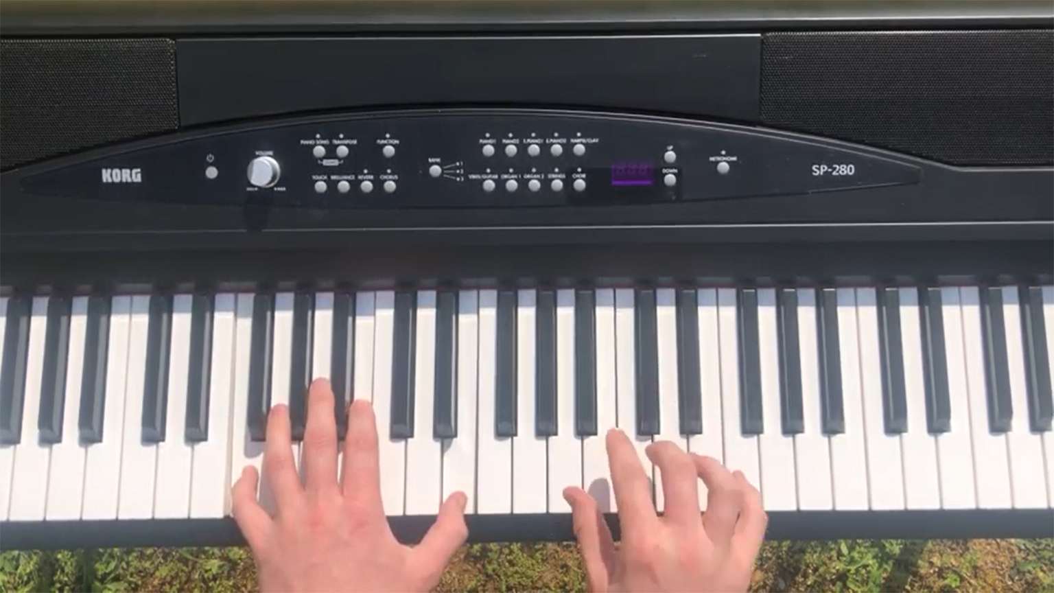 A pair of hands on an electric keyboard.
