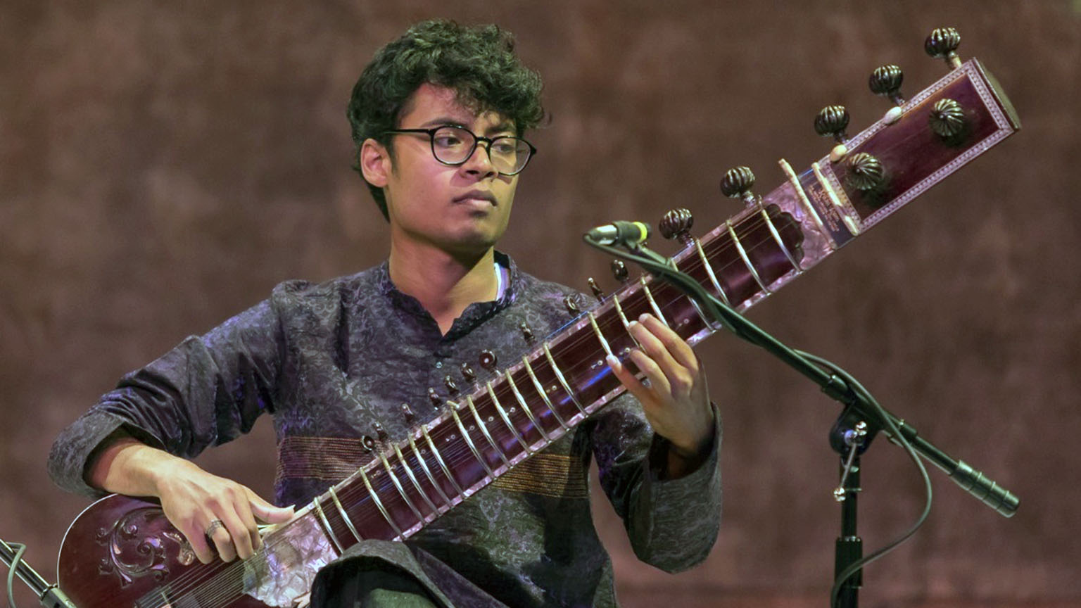Snehesh performing with a sitar, a classical hindustani instrument.