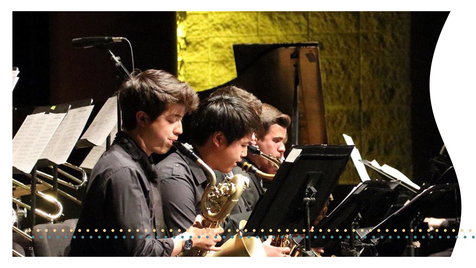 A group of students play saxaphones at a performance.