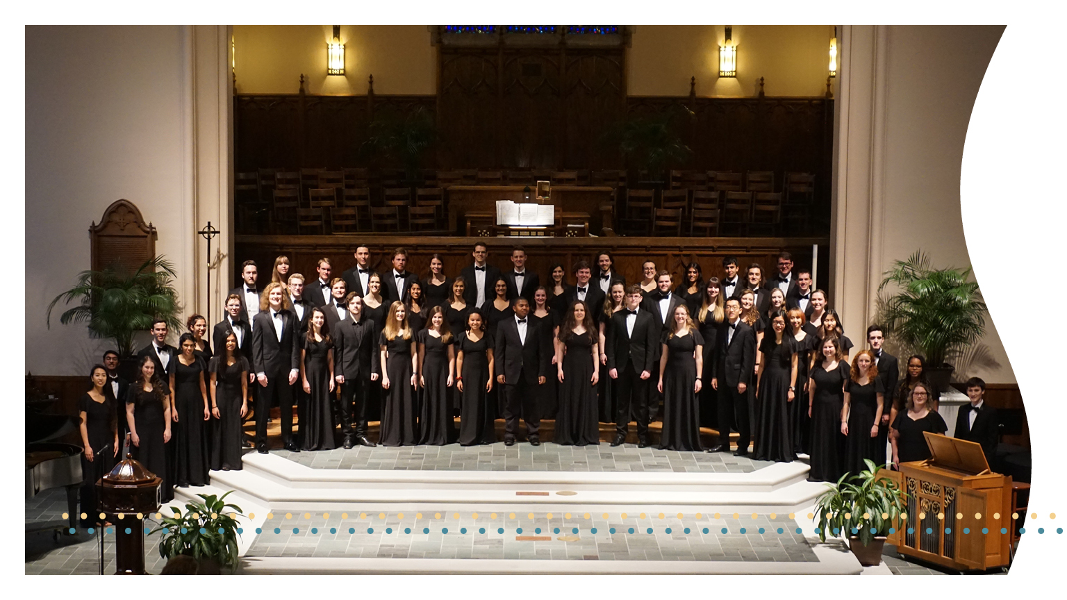  A group picture of the Georgia Tech Chamber Choir in a large auditorium.