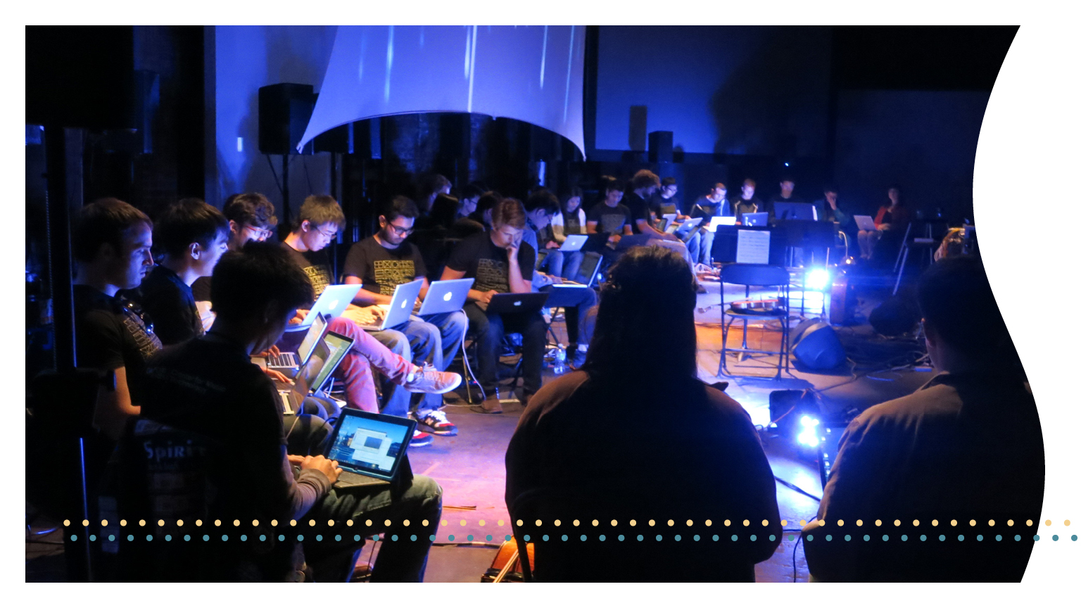 A group of students using laptops to create music.