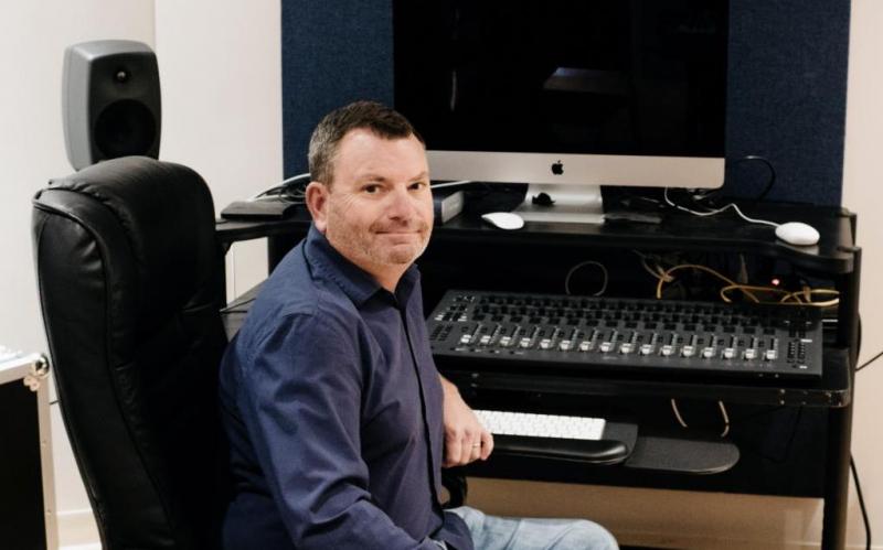 Chris Moore sits in the studio