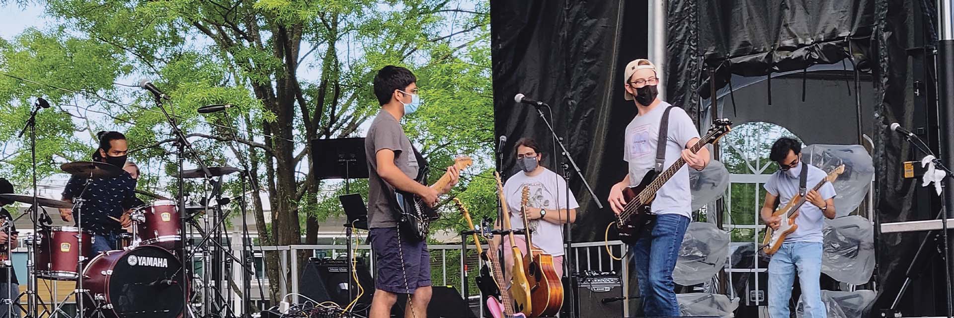 Rock and pop band performs on outdoor stage