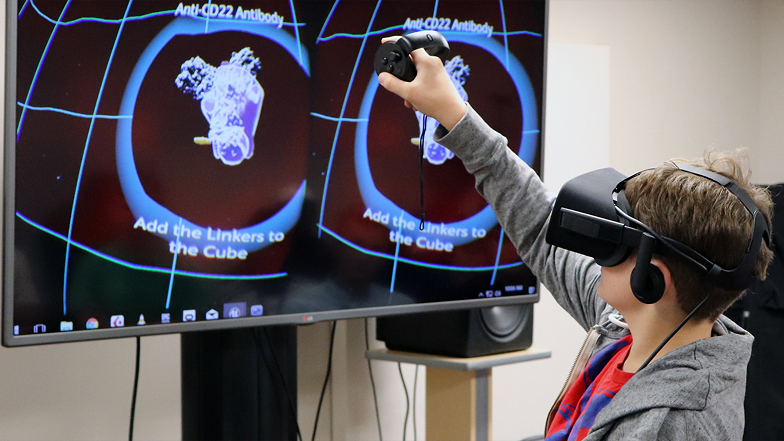 Younger student engaging with a VR headset during the pre-college program.