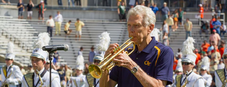 Cecil Welch performs trumpet on the field at Bobby Dodd Stadium