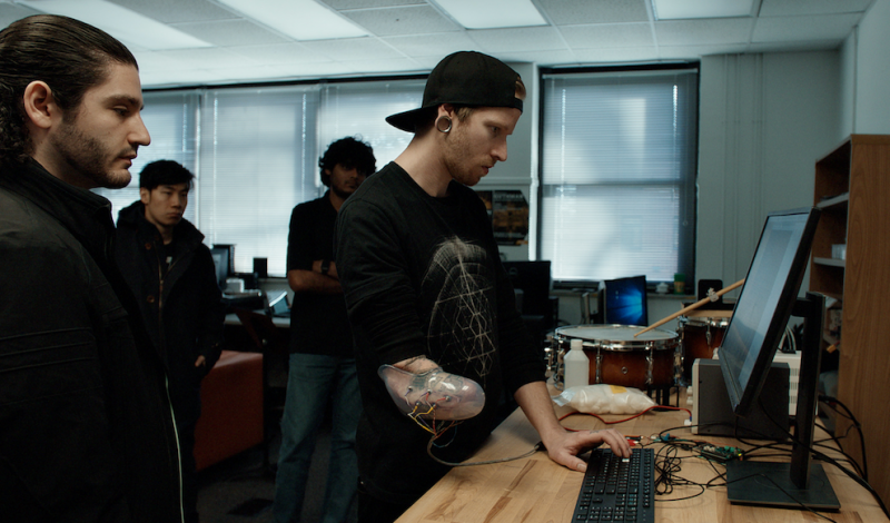 Jason Barnes works on a desktop in the Robotic Musicianship Lab