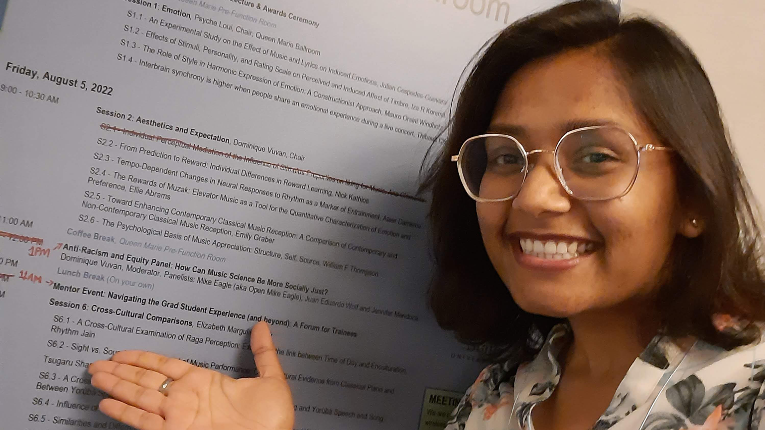 Headshot of Rhythm Jain in front of research poster