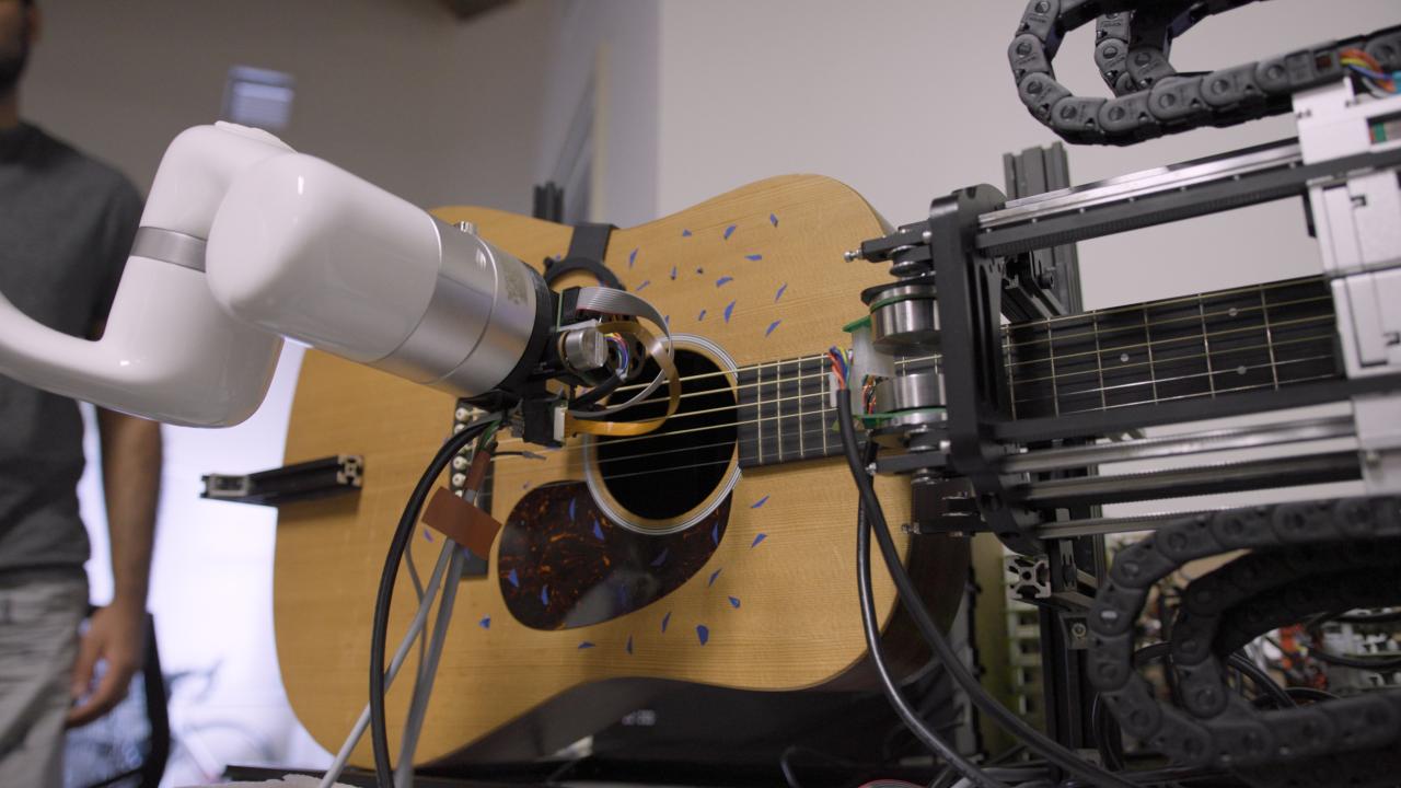 Robot arm playing guitar