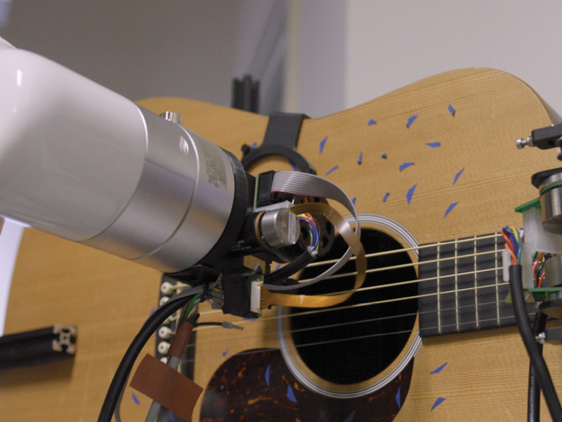 The guitar bot, a guitar playing robot arm