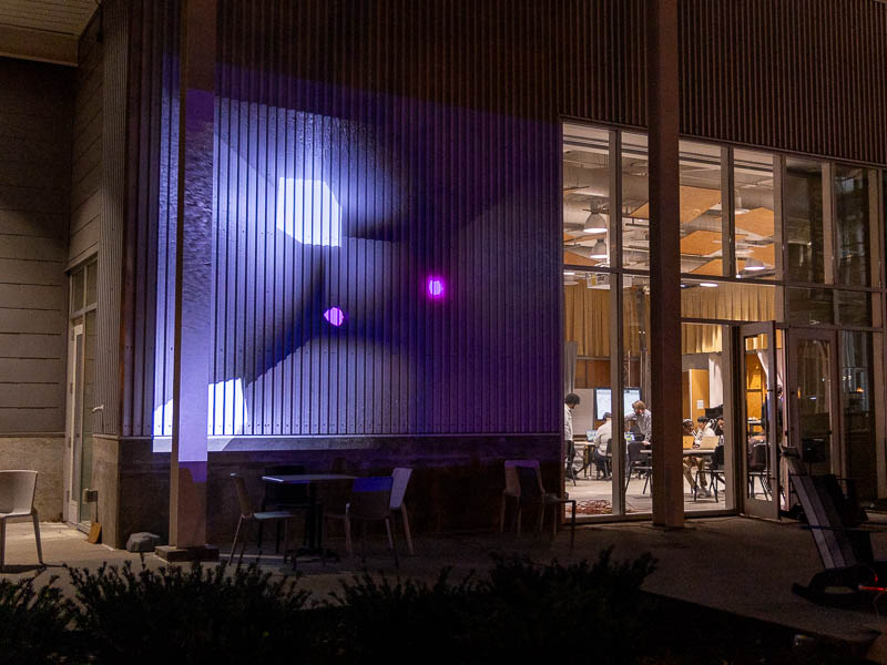 A projection of shapes on the outer wall of West Village 175