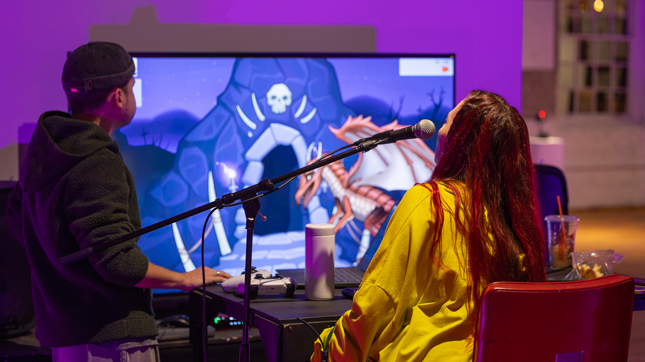 Person playing Echo Traveller, an RPG-style video game controlled by the player's humming or singing.